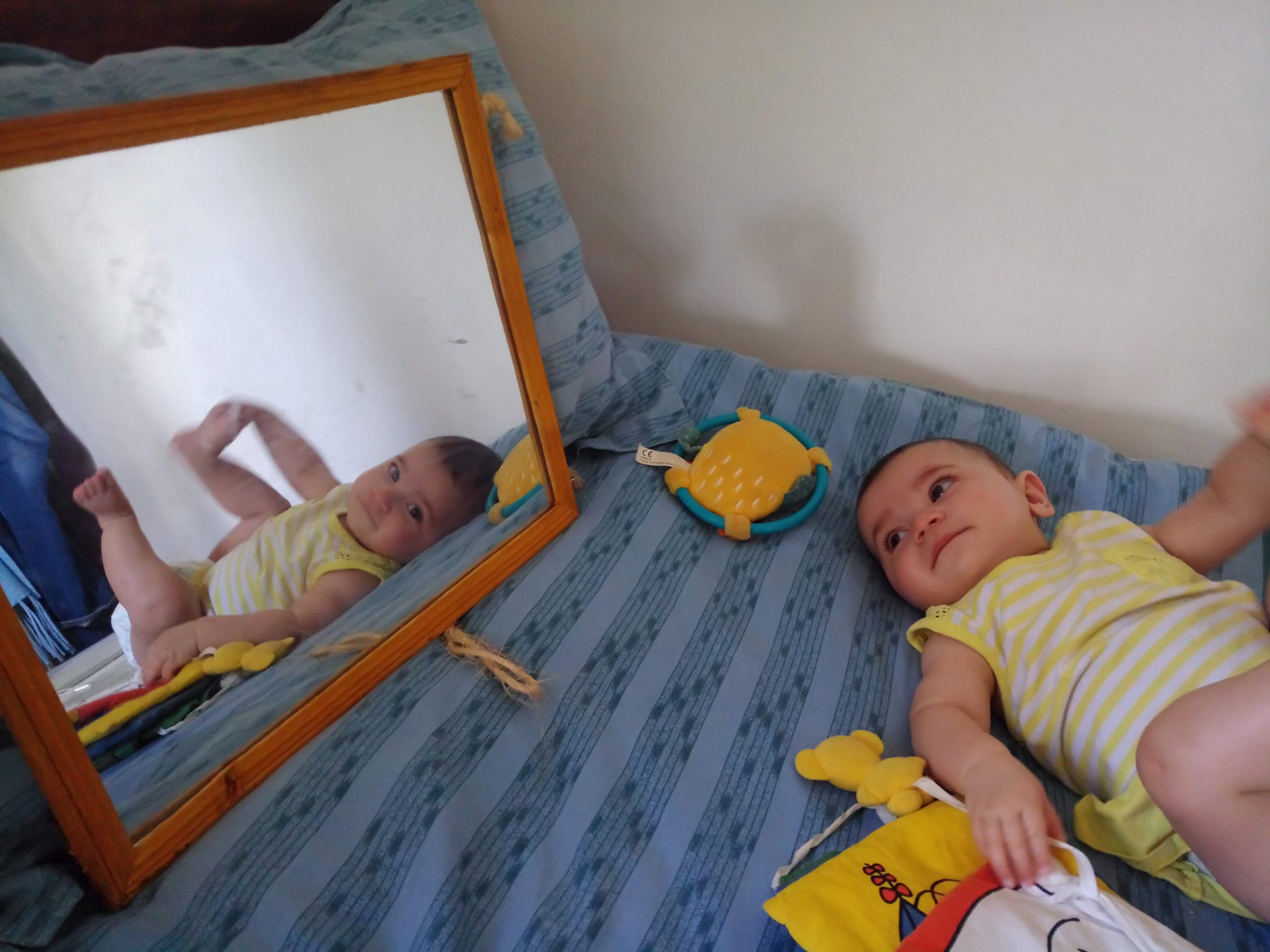 baby looking at a mirror